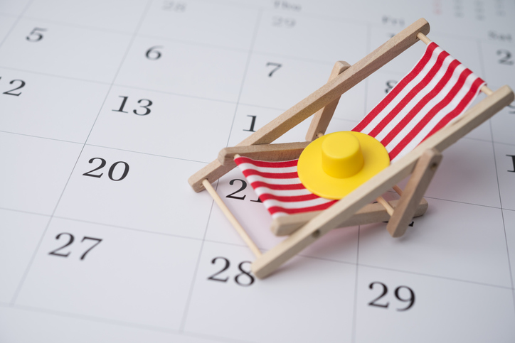 red beach chair and hat on white blank calendar background copy space.